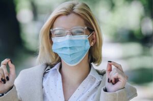 Women glasses foggy with mask