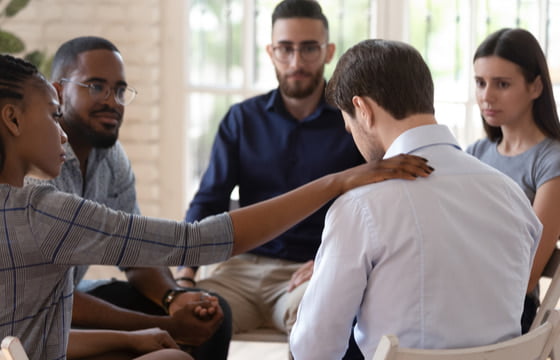 people sitting a circle during a recovery meeting
