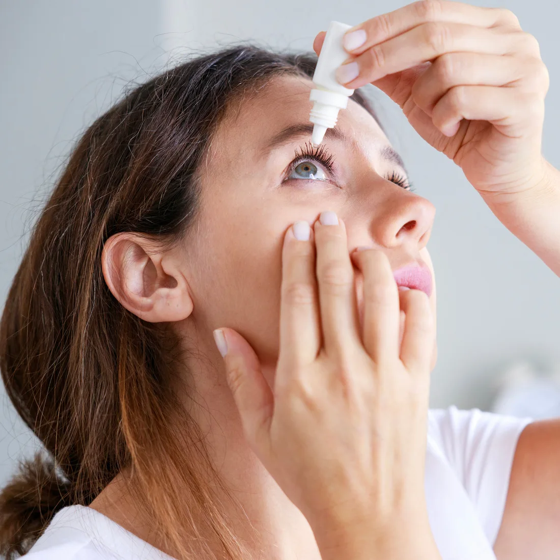 woman using drops for dry eye