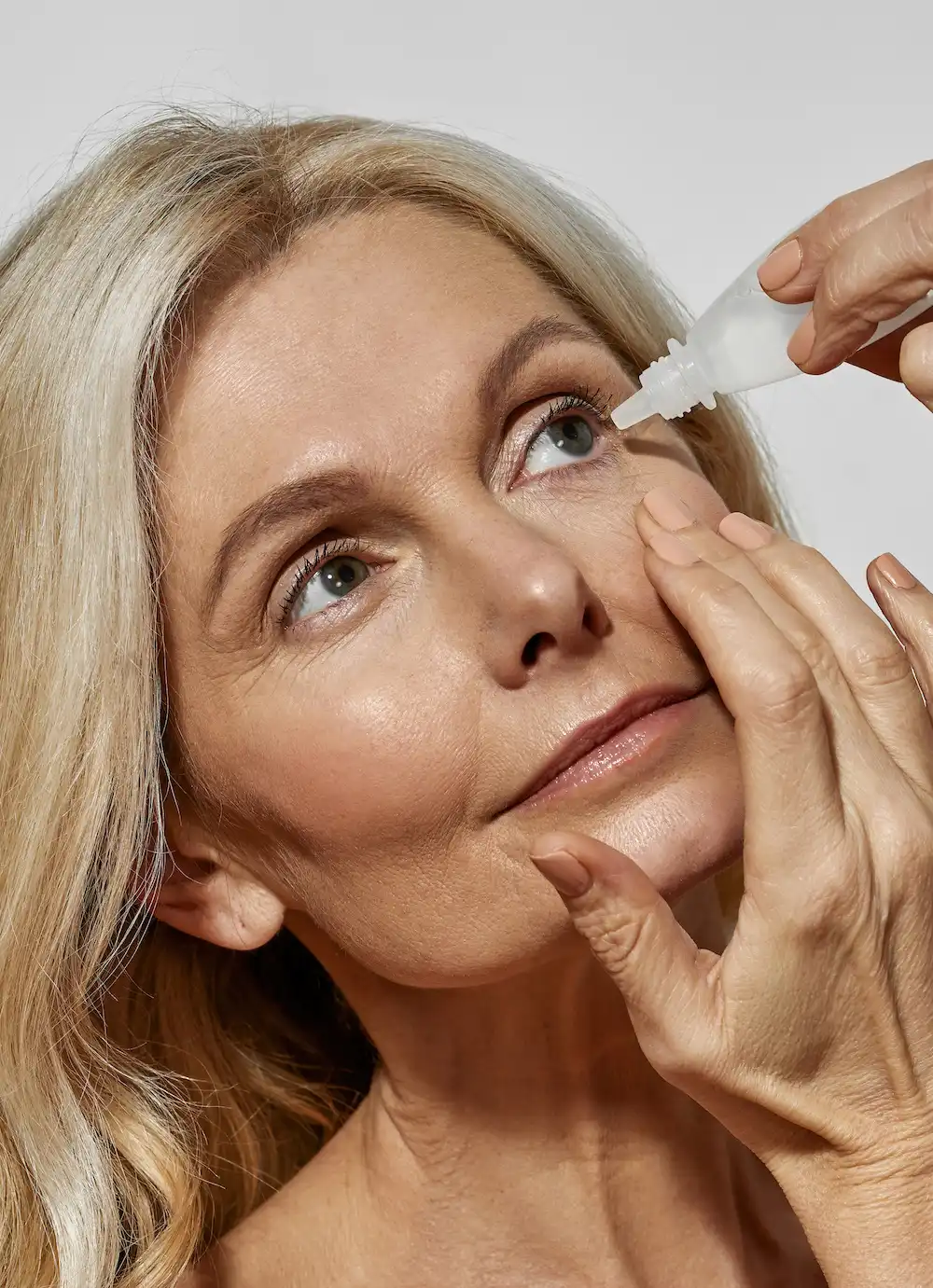 woman using eye drops for presbyopia