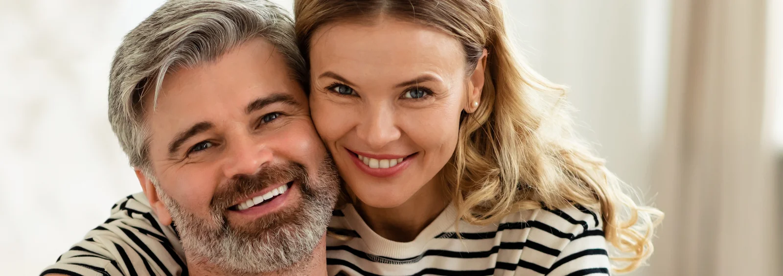 happy attractive mature couple looking into the camera