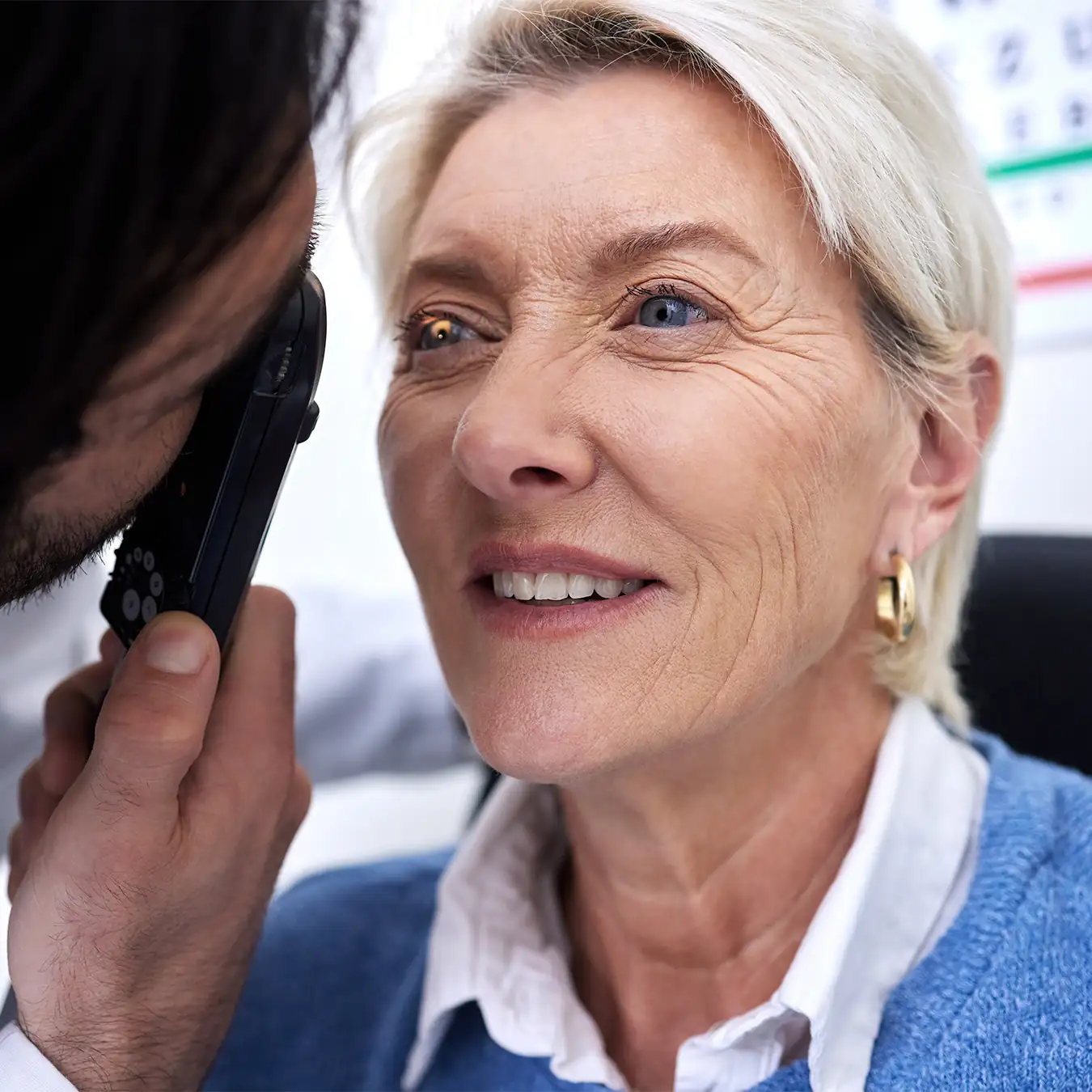 Eye doctor examining senior patient's retina