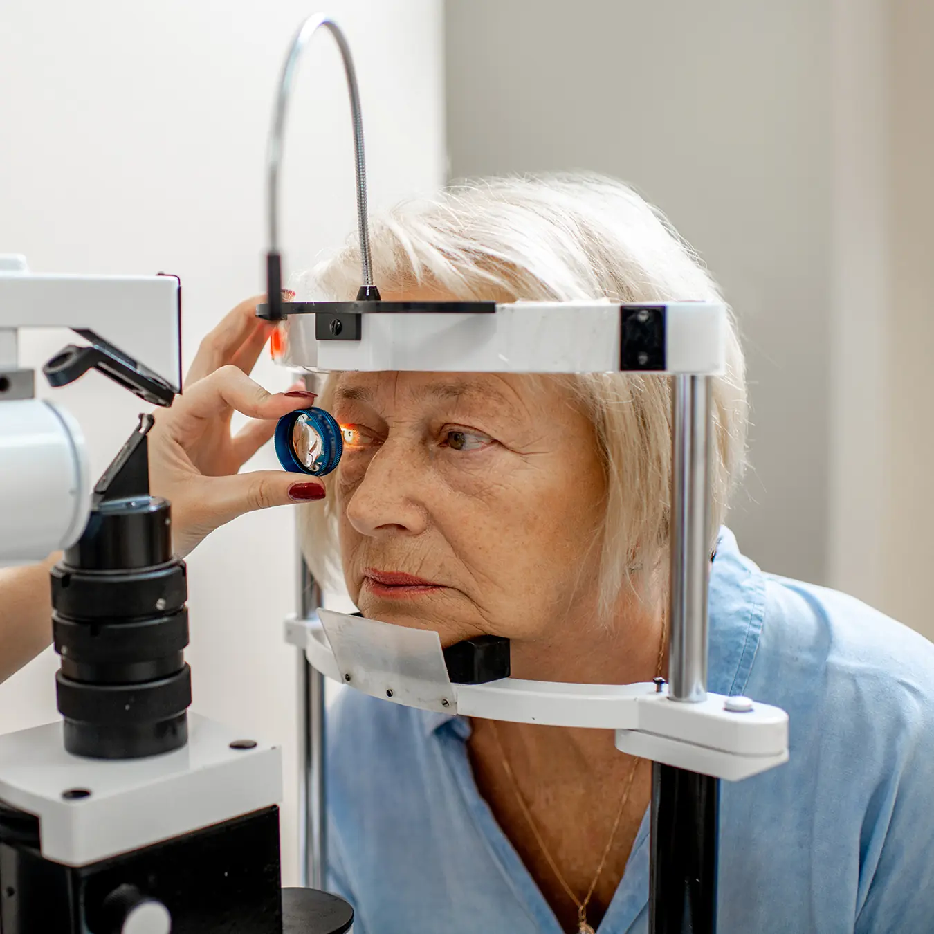 senior woman having eyes examined by ophthalmologist