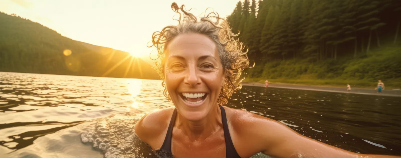 mature happy healthy woman swimming in a lake